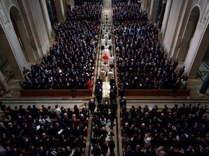 WASHINGTON, DC - FEBRUARY 20: Ushers guide the casket during the funeral Mass for Associat
