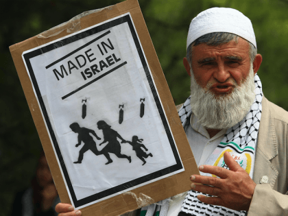 A pro-Palestinian demonstrator holds up an anti-Israel poster during a demonstration at the residence entrance of Israel's ambassador to Turkey Gabby Levy, in Ankara, on June 2, 2010 after the May 31 bloodshed on the Gaza-bound aid flotilla.