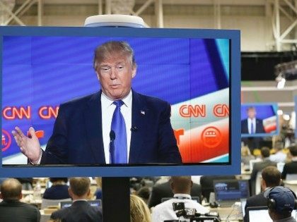 Republican Presidential Candidate Donald Trump is seen on television in the CNN filing roo