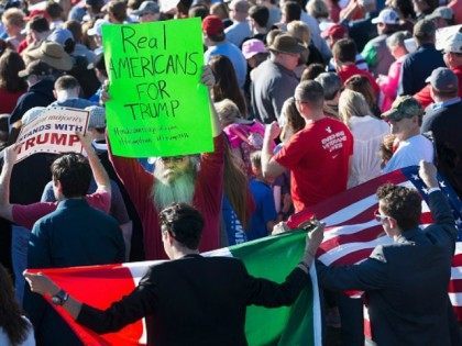 Demonstrators are confronted by a supporter of Republican presidential candidate Donald Tr