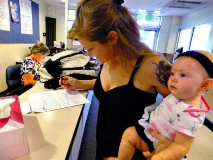 In this July 16, 2012, photo, Laura Fritz, 27, left, with her daughter Adalade Goudeseune