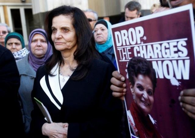 Palestinian activist Rasmieh Yousef Odeh (C) stands outside the federal courthouse after h