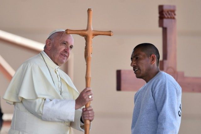 Pope Francis receives a cross made by an inmate during his visit to the CeReSo n. 3 penite