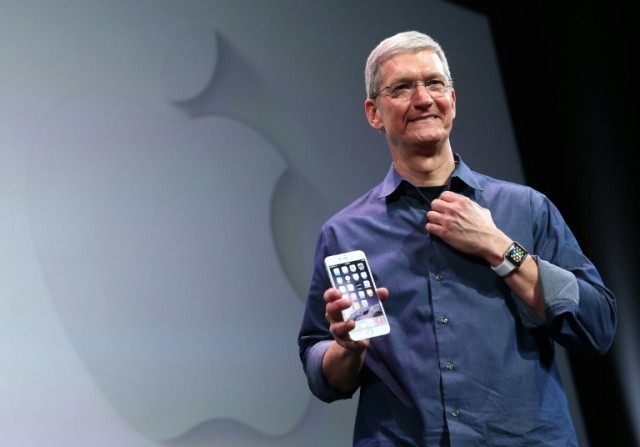 Apple CEO Tim Cook shows off the iPhone 6 on September 9, 2014 in Cupertino, California