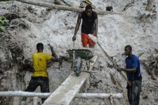 Gold diggers working with gold laced sands in the middle of the equatorial forest in Mayib