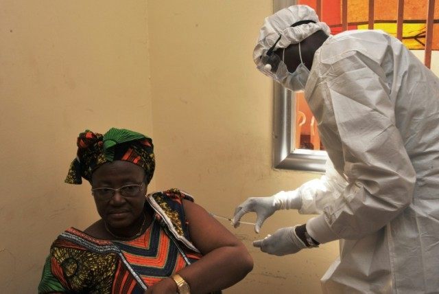 A woman gets vaccinated on March 10, 2015 in Conakry during the first clinical trials of t