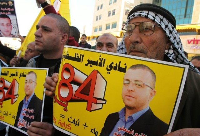Palestinians take part in a demonstration calling for the release of Mohammed al-Qiq, in t