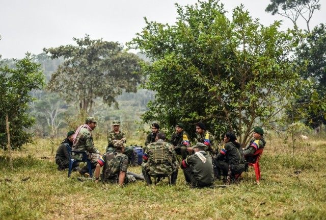 They still wear combat fatigues and carry rifles and machetes, but now FARC rebel troops s