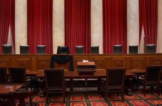 The chair of Justice Antonin Scalia is draped in black following his death on February 13,