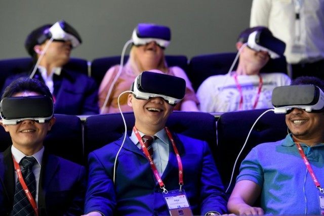 Visitors test the 'Oculus VR' virtual device on the Samsung stand at the Mobile World Cong