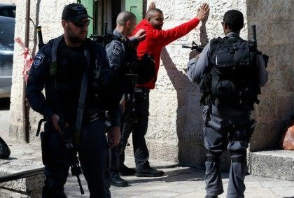 Israeli police body-check a Palestinian youth at Damascus Gate in the Old City of Jerusalem