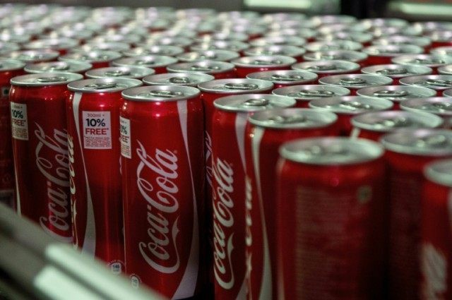 Coca Cola cans are seen on a production line at a bottling plant in Greater Noida some 50