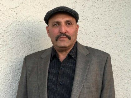 Local resident Elhamy Ibrahim, 62, poses for a portrait after attending a campaign rally f