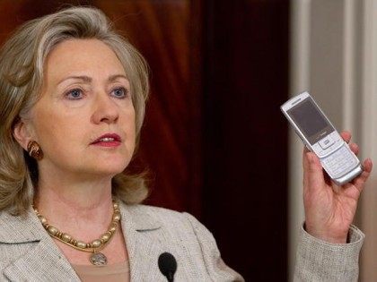 US Secretary of State Hillary Clinton holds up a cell phone as she explains how Americans can donate via text message to aid in helping victims of severe flooding in Pakistan, during a statement at the State Department in Washington, DC, August 4, 2010. AFP PHOTO / Saul LOEB (Photo …