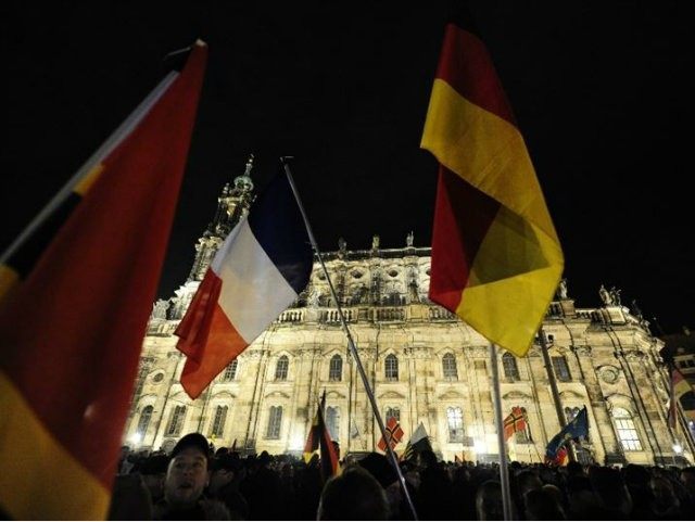 Supporters of the Islamophobic PEGIDA movement hold German and french …