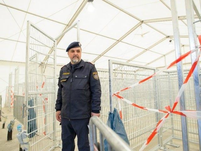 An Austrian police officer works at an empty refugee centre …