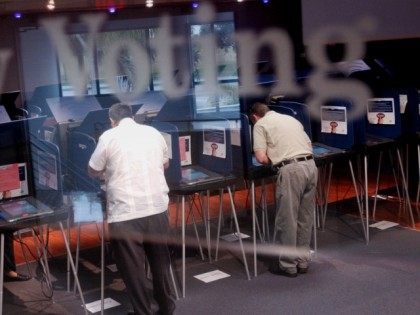 Two men were casting early ballots for the upcoming election at the Miami-Dade election headquarters in Miami, Fl. File