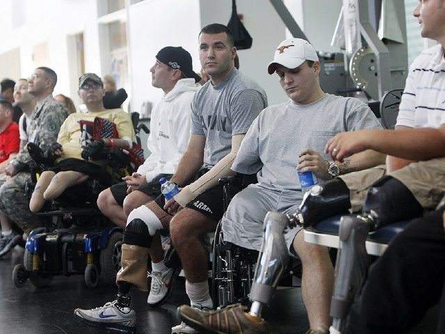 Wounded soldiers undergoing physical therapy wait for President Bush to visit a physical therapy lab for wounded soldiers at the Center For The Intrepid at the Brooke Army Medical Center in San Antonio, Thursday, Nov. 8, 2007. (AP Photo/Gerald Herbert)