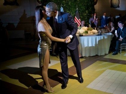 President Barack Obama kisses the dancer after doing the tango with her during the State D