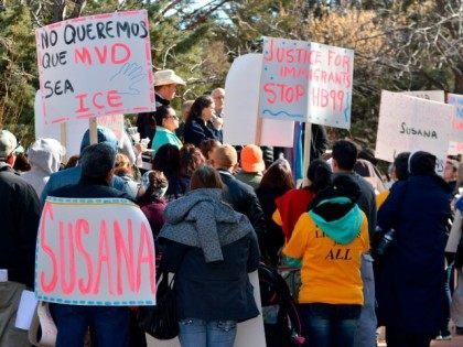 Jan. 25, 2016 file photo, immigrant advocates hold a rally outside the New Mexico statehouse to voice their opposition to a GOP-sponsored proposal that would make New Mexico REAL ID compliant by ending the practice of granting driver's licenses to immigrants in the country illegally. New Mexico Gov. Susana Martinez …