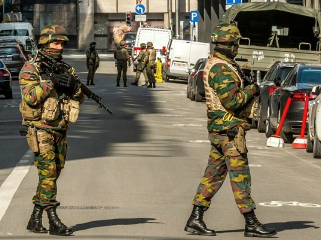 Soldiers block the access to road close to Maalbeek metro station in Brussels on March 22,