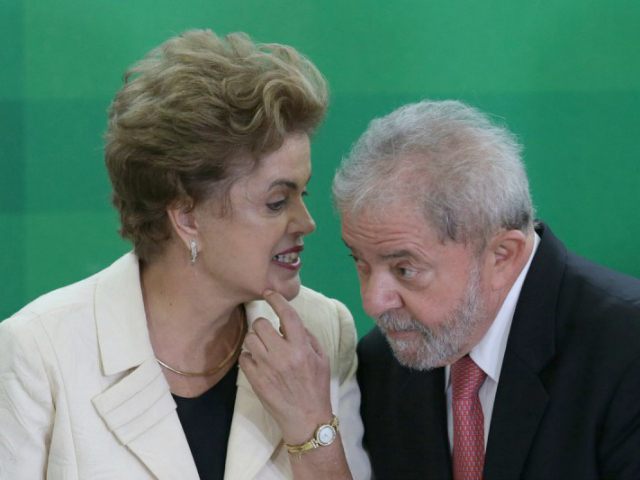 Brazil’s President Dilma Rousseff talks with former President Luiz Inacio Lula da Silva during his swearing-in ceremony as the chief of staff, at the Planalto presidential palace, in Brasilia, Brazil, Thursday, March 17, 2016. Silva was sworn in as his successor’s chief of staff on Thursday and Rousseff insisted he …