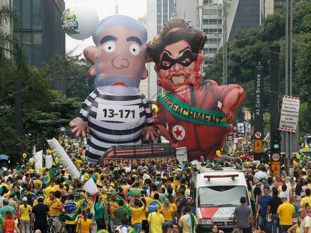 Demonstrators parade large inflatable dolls depicting Brazil's former President Luiz Inacio Lula da Silva in prison garb and current President Dilma Rousseff dressed as a thief, with a presidential sash that reads "Impeachment," in Sao Paulo, Brazil, Sunday, March 13, 2016. The corruption scandal at the state-run oil giant Petrobras …