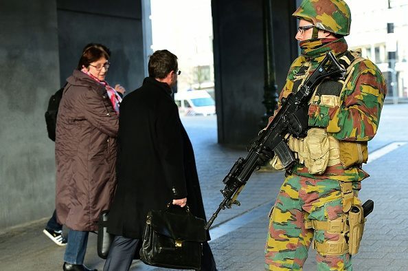 A Belgian soldier stands guard outside Brussels Central Station as people are allowed in s