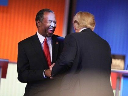 Republican presidential candidates Ben Carson and Donald Trump laugh during a commercial break during the Fox Business Network Republican presidential debate at the North Charleston Coliseum and Performing Arts Center on January 14, 2016 in North Charleston, South Carolina.