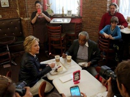 Democratic presidential candidate Hillary Clinton sits with Congressman Charles Rangel at Make My Cake in Harlem before an appearance at the Apollo Theater on March 30, 2016 in New York City.