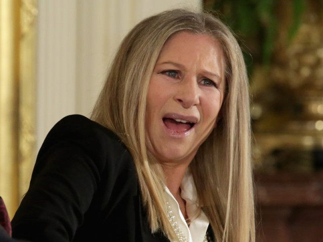 WASHINGTON, DC - NOVEMBER 24: Entertainer Barbra Streisand (R) reacts to the words Presid
