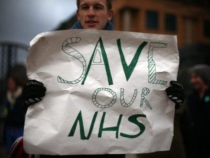 LONDON, UNITED KINGDOM - JANUARY 12: A junior doctor holds a poster as he takes part in a picket outside Kings College Hospital on January 12, 2016 in London, United Kingdom.