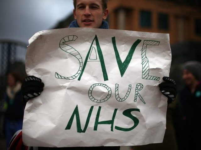 LONDON, UNITED KINGDOM - JANUARY 12: A junior doctor holds a poster as he takes part in a