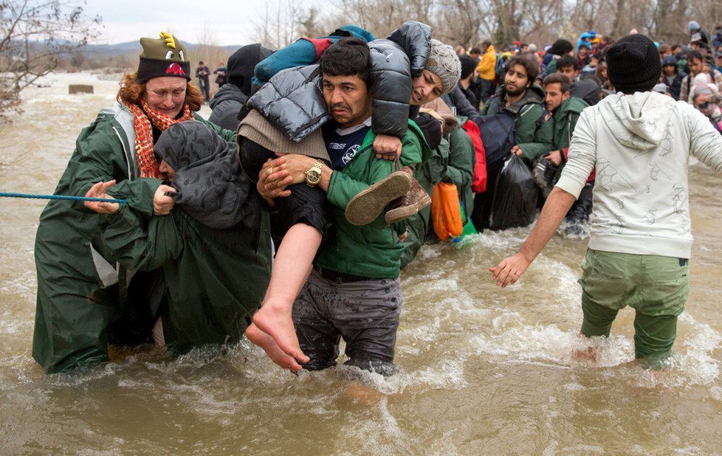 IDOMENI, GREECE - MARCH 14: Migrants try to cross a river after leaving the Idomeni refugee camp on March 13, 2016 in Idomeni, Greece. The decision by Macedonia to close its border to migrants on Wednesday has left thousands of people stranded at the Greek transit camp. The closure, following the lead taken by neighbouring countries, has effectively sealed the so-called western Balkan route, the main migration route that has been used by hundreds of thousands of migrants to reach countries in western Europe such as Germany. Humanitarian workers have described the conditions at the camp as desperate, which has been made much worse by recent bouts of heavy rain. (Photo by Matt Cardy/Getty Images)