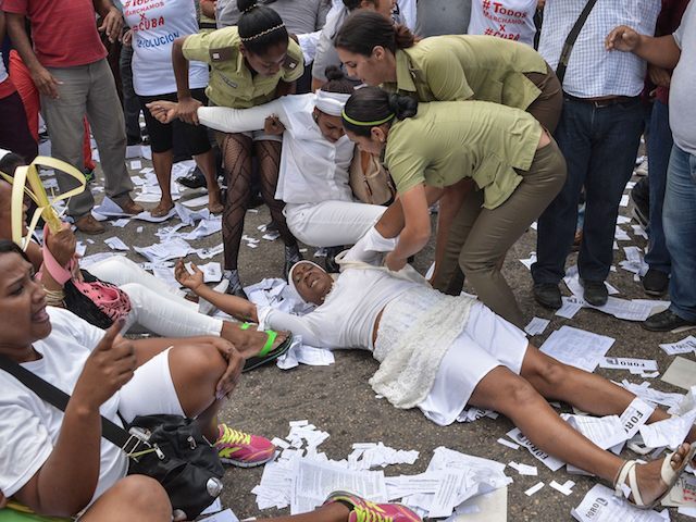 Members of dissident group "Ladies in White", wives of former political prisoners, are detained during their protest on March 20, 2016 in Havana. President Barack Obama flew out of the United States on Sunday bound for a historic three-day visit to the communist-ruled island of Cuba. It is the first visit to Cuba by a sitting US president since Fidel Castro's guerrillas overthrew the US-backed government of Fulgencio Batista in 1959 and the first since President Calvin Coolidge's trip to the island 88 years ago. / AFP / ADALBERTO ROQUE (Photo credit should read ADALBERTO ROQUE/AFP/Getty Images)