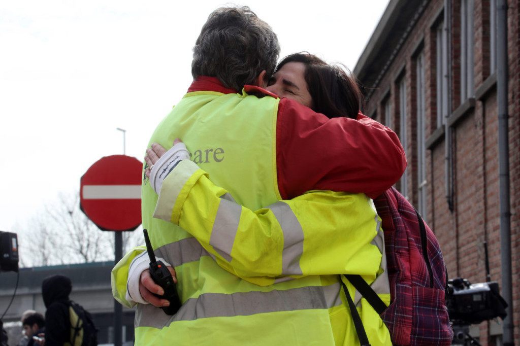 BRUSSELS, BELGIUM - MARCH 22: Airport staff comfort each other as passengers are evacuated from Zaventem Bruxelles International Airport after a terrorist attack on March 22, 2016 in Brussels, Belgium. At least 28 people are though to have been killed after Brussels airport and a Metro station were targeted by explosions. The attacks come just days after a key suspect in the Paris attacks, Salah Abdeslam, was captured in Brussels. (Photo by Sylvain Lefevre/Getty Images)