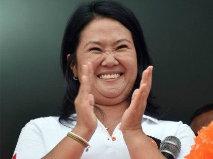 Peruvian presidential candidate for the April 10 general election, Keiko Fujimori leader of the Fuerza Popular Party, applauds during a campaign rally in Lima, on February 9, 2016. Fujimori, daughter of imprisoned Peruvian former President Alberto Fujimori, consistently leads the polls. AFP PHOTO/CRIS BOURONCLE / AFP / CRIS BOURONCLE (Photo …