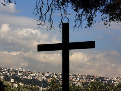 The town of Ajaltoun is seen behind a cross standing at the Christian Maronite church of S