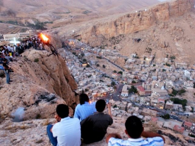 FILE - In this Wednesday, Sept. 13, 2006 file photo, Thousands of Syrians, most of them Christians, celebrate the Christian Day of the Cross, by setting a fire on top of a mountain in the village of Maaloula, north of Damascus. Syrian government troops battled al-Qaida-linked rebels over a regime-held …