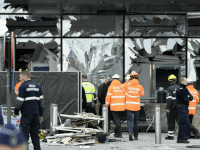 Members of the civil protection walk outside the damaged front of Brussels Airport Getty Brussels
