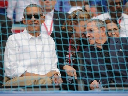 President Barack Obama (L) and Cuban President Raul Castro arrive for an exposition game b