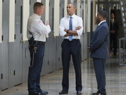 Barack Obama, alongside Charles Samuels (R), Bureau of Prisons Director, and Ronald Warlic