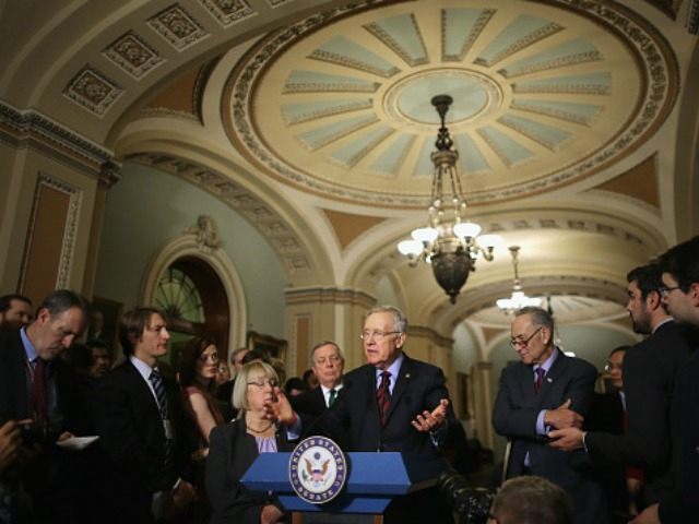Senate Minority Leader Harry Reid (D-NV) (C) answers reporters' questions duirng a ne