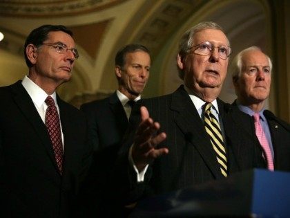 Senate Majority Leader Sen. Mitch McConnell (R-KY) (3rd L) speaks as (L-R) Sen. John Barrasso (R-WY), Sen. John Thune (R-SD), and Senate Majority Whip Sen. John Cornyn (R-TX) listen during a news briefing after the weekly Republican policy luncheon March 8, 2016 on Capitol Hill in Washington, DC.