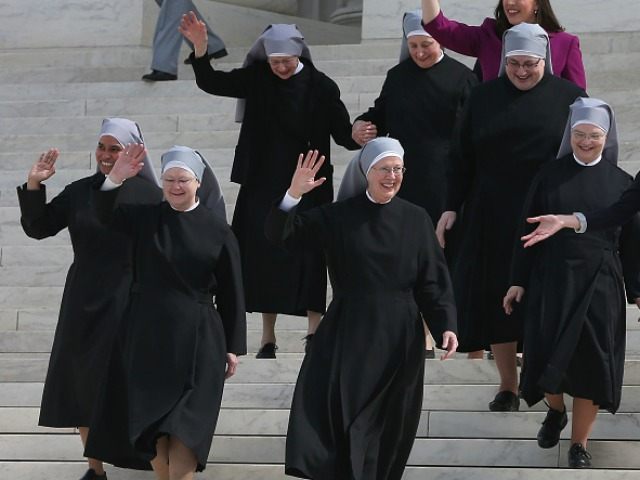 Mother Loraine Marie Maguire, (C), of the Little Sisters of the Poor, walks down the steps of the US Supreme Court after aruments, March 23, 2016 in Washington, DC.