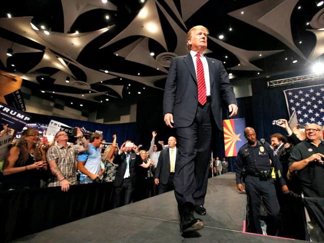 Republican presidential candidate Donald Trump walks on stage to speak before a crowd of 3,500 Saturday, July 11, 2015, in Phoenix. (AP Photo/Ross D. Franklin)