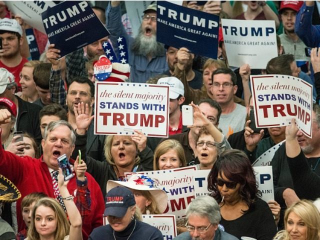 Donald Trump supporters cheer on the Republican presidential candidate before a campaign r