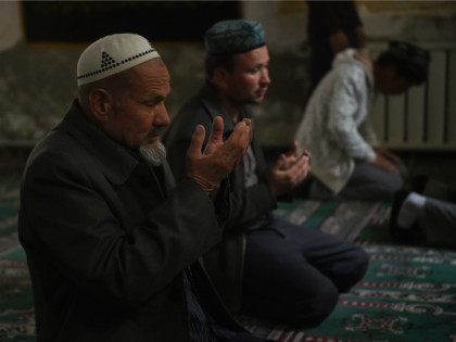 CHINA, HOTAN : This photo taken on April 16, 2015 shows Uighur men praying in a mosque in Hotan, in China's western Xinjiang region. Chinese authorities have restricted expressions of religion in Xinjiang in recent years such as wearing veils, fasting during Ramadan and young men growing beards, sparking widespread …