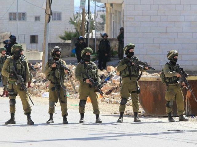 Israeli security forces hold position near the Jewish settlement of Kiryat Arba in the occ