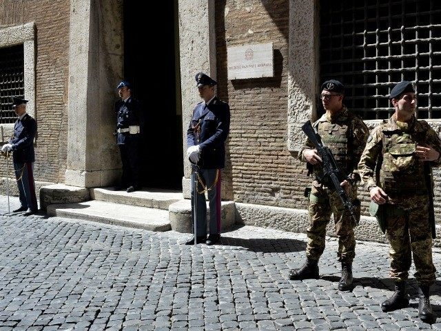 Policemen and soldiers stand guard outside the Italian national Anti-mafia services (Direzione Nazionale Antimafia - DNA) headquarters on May 7, 2015 in Rome.